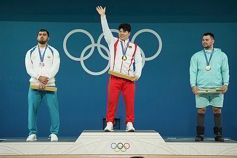 Paris Olympics men's 102kg weightlifting: Akbar Djuraev of Uzbekistan, silver, Liu Huanhua of China, gold, and Individual Neutral Athlete Yauheni Tsikhantsou, bronze